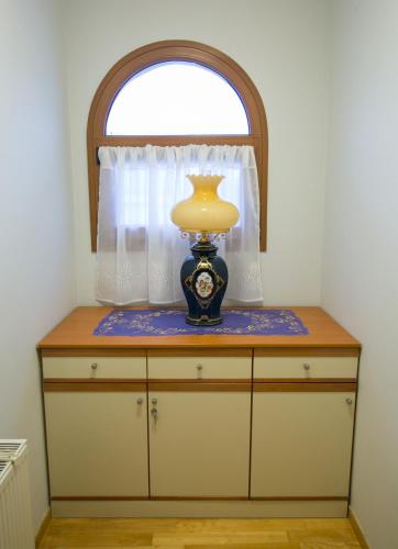 a vase sitting on top of a dresser with a window at Vier Luxury House in Serres
