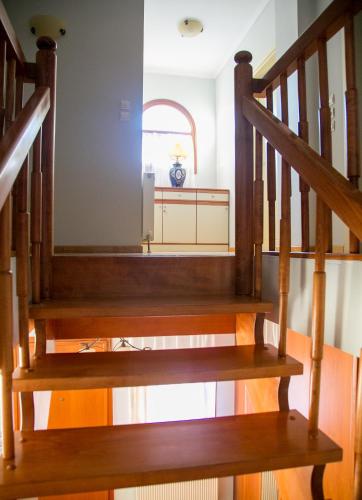 a staircase in a home with wooden stairs at Vier Luxury House in Serres