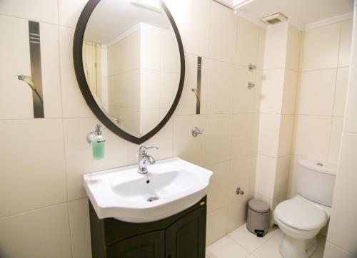 a bathroom with a sink and a mirror and a toilet at Vier Luxury House in Serres