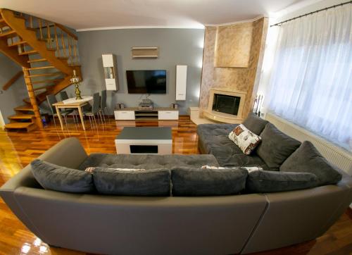 a living room with a couch and a fireplace at Vier Luxury House in Serres