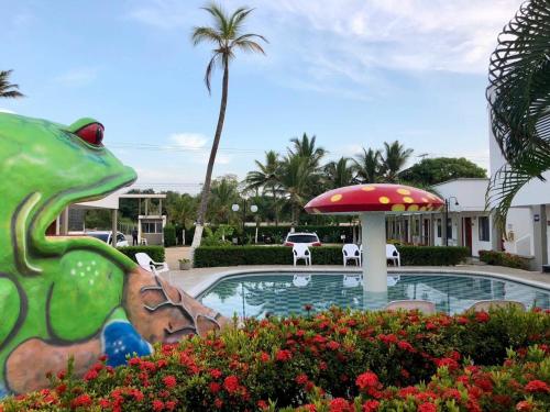 a pool at a resort with a frog statue at Hotel La Fragata in Coveñas