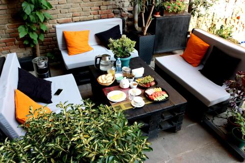 a table with plates of food on a patio at Vere Side Hotel in Tbilisi City