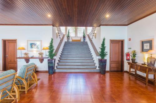 a room with a staircase with chairs and a table at FLH Luxury Villa Mar with Private Sea Access in Caniçal