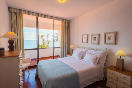 1 dormitorio con 1 cama y vistas al océano en FLH Luxury Villa Mar with Private Sea Access, en Caniçal