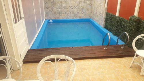 a large swimming pool in a room with chairs at Hotel Florencia in Necochea