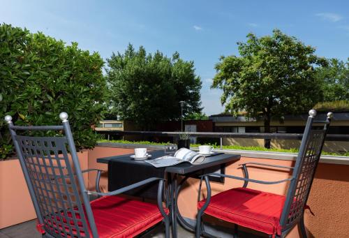 a table and two chairs sitting on a patio at Romantik Hotel Residenz am See in Meersburg