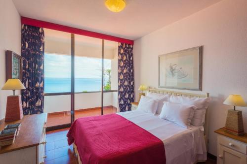 a bedroom with a large bed and a large window at FLH Luxury Villa Mar with Private Sea Access in Caniçal