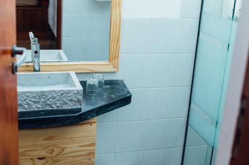 a bathroom with a sink and a mirror at Ecolodge La Estancia in Comunidad Yumani