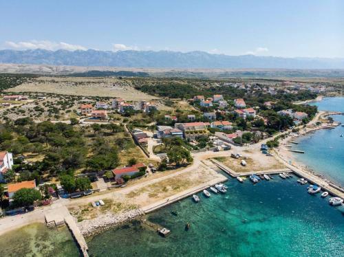 an aerial view of a small island in a body of water at Apartment Rino, only 30m from the sea in Pag