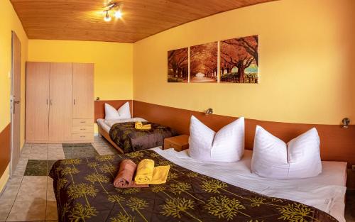 a hotel room with two beds and a bedroom with a bedsenalsenalsenalsenal at Apartmany Veverica in Liptovský Mikuláš