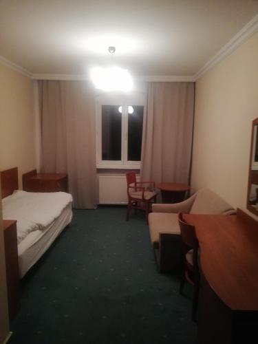 a hotel room with two beds and a window at Hostel Ratuszowy in Bydgoszcz