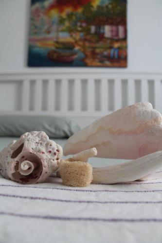 a stuffed animal sitting on a bed next to a stuffed animal at B&B Villa Luna in Bayahibe