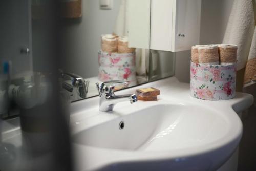 a white bathroom sink with a mirror and towels at Vintage Village House in Gastouri