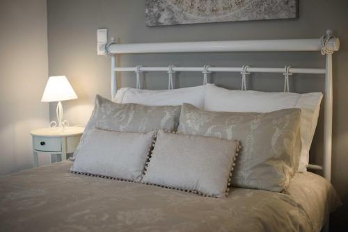 a bedroom with a bed with pillows at Vintage Village House in Gastouri