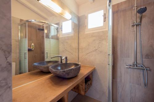 two sinks on a wooden counter in a bathroom at Ionian Villas in Volimes