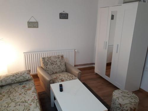 a living room with a couch and a table at Apartman ANA in Slavonski Brod