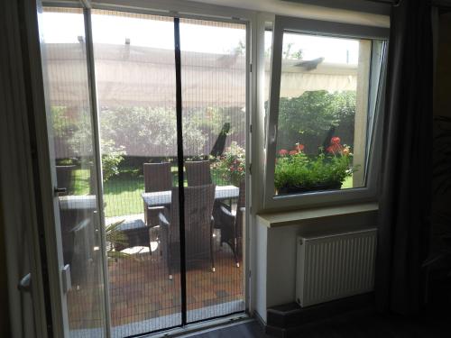 a sliding glass door to a patio with a table at Idyll im Land der 1000 Seen in Liessow