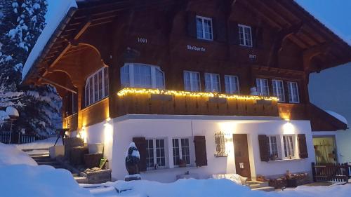 a large building with lights on it in the snow at Chalet Waldperle in Arosa