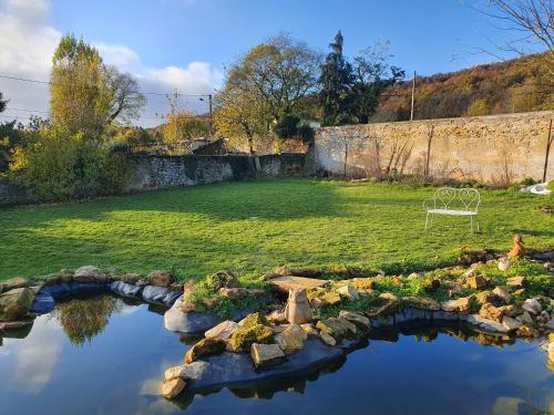 a garden with a bench in the middle of a field at Chez marie poppins in Rozérieulles
