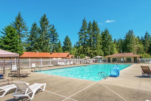 a large swimming pool with chairs and a house at Chehalis Camping Resort Cottage 1 in Onalaska