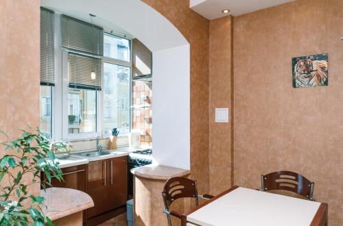 a kitchen with a table and a sink at HouseHome in Kyiv