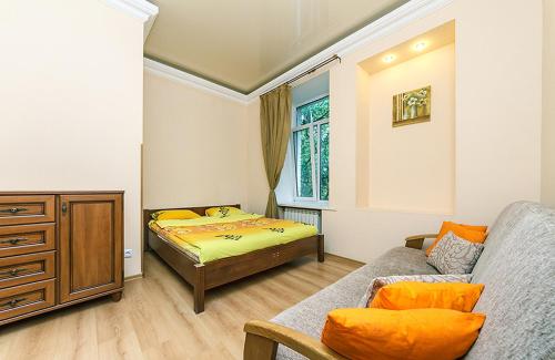 a small bedroom with a bed and a couch at HouseHome in Kyiv