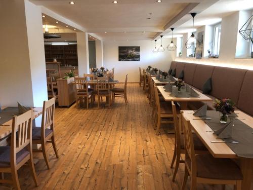 a dining room with wooden tables and chairs at Gästehaus Kling in Rettenbach