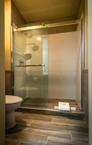 a bathroom with a glass shower with a toilet at The Mill Casino Hotel in North Bend