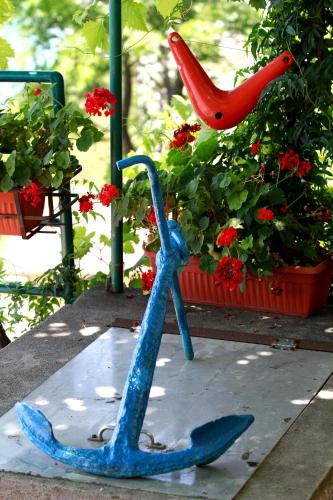 a blue statue of a anchor next to a plant at Lighthouse Apartments in Budva