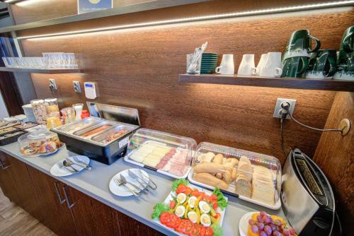 a buffet with food on a counter in a restaurant at Penzion Královská Cesta in Brno