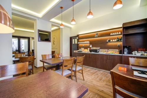 a restaurant with wooden tables and chairs and a counter at Penzion Královská Cesta in Brno