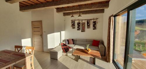 a living room with a couch and a table at Apartments Pemikas I in Liptovský Mikuláš
