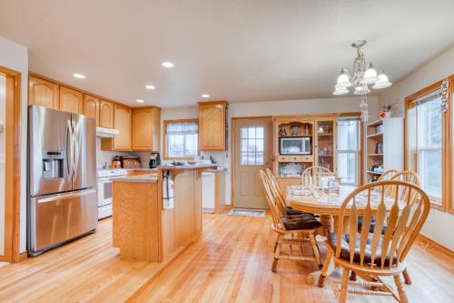a kitchen with a table and chairs and a refrigerator at Spacious Seaside Home with an Ocean View in Seaside