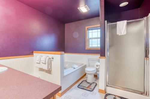 a purple bathroom with a toilet and a shower at Spacious Seaside Home with an Ocean View in Seaside