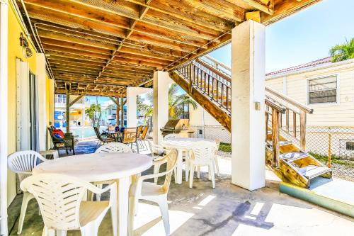 a patio with tables and chairs and a staircase at Burgundy Breeze in Tavernier