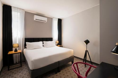 Postel nebo postele na pokoji v ubytování The PopCity Hotel
