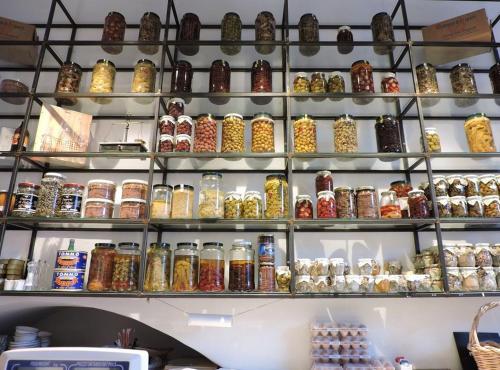 a shelf filled with lots of different types of jars at Boutique Hotel I Cinque Balconi in Santa Marina Salina