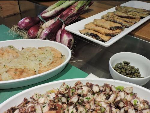 three plates of food on a table with different foods at Boutique Hotel I Cinque Balconi in Santa Marina Salina