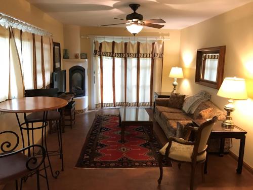 a living room with a couch and a table at Casa Blanca Inn and Suites in Farmington