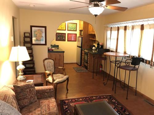 a living room with a couch and a table at Casa Blanca Inn and Suites in Farmington