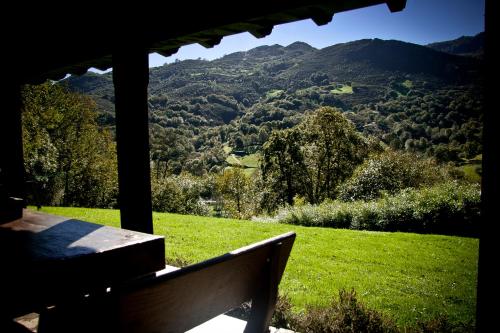a bench sitting on a porch with a view of a mountain at Casa Rural La Retuerta in Nava