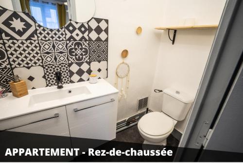 a bathroom with a toilet and a sink at Les Apparts de Blossac Poitiers in Poitiers