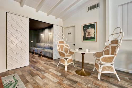 a living room with a table and chairs at Dive Palm Springs in Palm Springs
