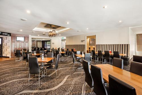 a large dining room with tables and chairs at National Hotel Complex Bendigo in Bendigo