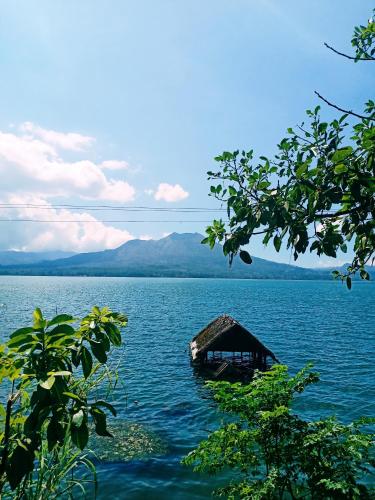 a small hut in the middle of a large body of water at Triangle House and hot spring in Kintamani