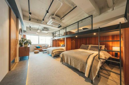 a bedroom with two bunk beds and a couch at illi Shimokitazawa in Tokyo