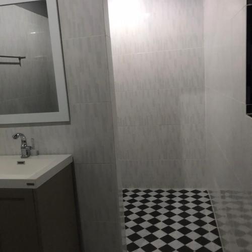 a bathroom with a sink and a shower with a mirror at Aladdin Guest House in Phi Phi Don