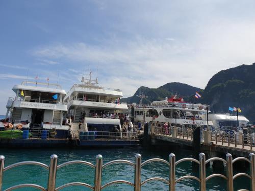 two boats are docked at a dock in the water at Aladdin Guest House in Phi Phi Don