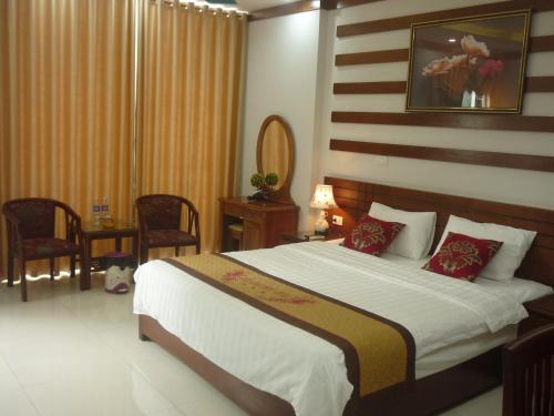 a bedroom with a large bed with red pillows at Asia Apartment Hotel Bac Ninh in Bắc Ninh
