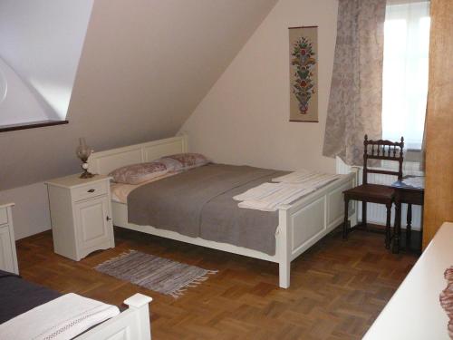Postel nebo postele na pokoji v ubytování Zagrodowa Osada